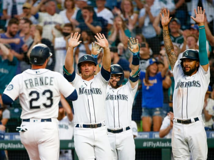 Jul 26, 2021; Seattle, Washington, USA; Seattle Mariners third baseman Kyle Seager (15, left), first baseman Luis Torrens (22) and shortstop J.P. Crawford (3, right) greet designated hitter Ty France (23) as he scores a run against the Houston Astros during the fourth inning at T-Mobile Park. Seager and Crawford also scored runs on the play.